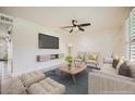 A well-lit living room features stylish decor, a flat screen tv, and large windows at 5166 N 83Rd St, Scottsdale, AZ 85250