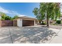 Single-story home with a wide driveway, desert landscaping, and a two-car garage at 560 E San Pedro Ave, Gilbert, AZ 85234