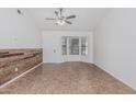 Open living area featuring a stylish accent wall, ceiling fan, and bright natural light at 560 E San Pedro Ave, Gilbert, AZ 85234