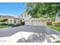 Gorgeous two-story home featuring a three-car garage and a large driveway with beautiful curb appeal at 5726 W Park View Ln, Glendale, AZ 85310