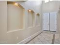 Bright foyer with recessed lighting, decorative niches, tiled floor, and a double-door entry at 5726 W Park View Ln, Glendale, AZ 85310
