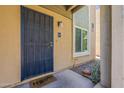 Inviting entrance with a secure door, updated lighting, xeriscaping, and a 'Home' welcome mat at 601 E Palo Verde Dr # 27, Phoenix, AZ 85012