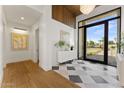 Elegant entryway with tiled flooring, modern decor, and a bright view to the landscaped outdoors at 6147 E Desert Cove Ave, Scottsdale, AZ 85254