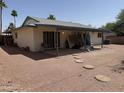 Backyard patio with desert landscaping with mature palms at 6543 E Palm Ln, Scottsdale, AZ 85257