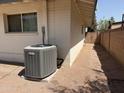 New HVAC unit on side of house, desert landscaping at 6543 E Palm Ln, Scottsdale, AZ 85257
