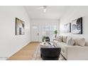 Cozy living room with comfortable seating, bright light and wood laminate flooring at 6863 W Sunnyside Dr, Peoria, AZ 85345
