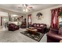 Inviting living room featuring leather furniture, carpet flooring, and open access to other living areas at 7015 W Melody Dr, Laveen, AZ 85339