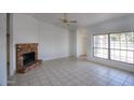 Bright living room featuring tile floors, a brick fireplace, and a large window with natural light at 722 W Topeka Dr, Phoenix, AZ 85027