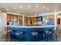 Spacious kitchen with breakfast bar, custom cabinets, stainless steel appliances, and designer backsplash at 8606 E Arroyo Seco Rd, Scottsdale, AZ 85266