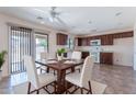 Cozy dining area showcasing a wooden table setting next to a bright, open kitchen space at 950 E Kelsi Ave, San Tan Valley, AZ 85140