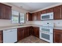 Bright kitchen features extensive cabinetry and modern appliances, offering functionality and style at 950 E Kelsi Ave, San Tan Valley, AZ 85140