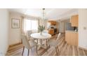 Cozy dining area with a chandelier, a round table, and hardwood floors near the kitchen at 10951 N 91St Ave # 16, Peoria, AZ 85345