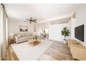 Open-concept living room featuring hardwood floors, neutral walls, and ample natural light at 10951 N 91St Ave # 16, Peoria, AZ 85345