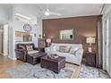 Inviting living room featuring a decorative ceiling fan, leather furniture, and stylish accents at 14203 N 19Th Ave # 2036, Phoenix, AZ 85023