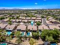 Aerial view of a residential neighborhood showcasing houses with pools and desert landscaping on a sunny day at 14717 N 97Th Pl, Scottsdale, AZ 85260