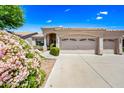 A well-maintained home featuring a two-car garage, desert landscaping, and a sunny desert community setting at 14717 N 97Th Pl, Scottsdale, AZ 85260