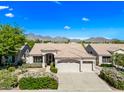 Beautiful single-story home with a tile roof, well-manicured lawn, and mountain views in a desert community at 14717 N 97Th Pl, Scottsdale, AZ 85260