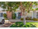 Charming townhouse entrance featuring a brick chimney and well-maintained front yard landscaping at 1600 N Saba St # 143, Chandler, AZ 85225