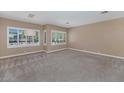Bright bedroom showcasing neutral walls, carpet floors and sunny windows with plantation shutters at 1621 W Wildwood Dr, Phoenix, AZ 85045