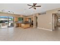 Open-concept kitchen and eating area with tile flooring, center island and stainless steel appliances at 1621 W Wildwood Dr, Phoenix, AZ 85045