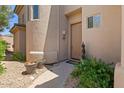 Inviting entryway with a charming door and potted plants for added curb appeal at 16420 N Thompson Peak Pkwy # 1002, Scottsdale, AZ 85260