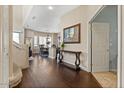 Elegant foyer with hardwood floors, a staircase, and entry to the dining room at 16420 N Thompson Peak Pkwy # 1002, Scottsdale, AZ 85260