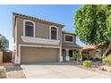Traditional two-story home with desert landscaping, two-car garage, and covered entry porch at 16527 W Ironwood St, Surprise, AZ 85388