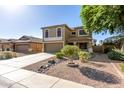 Exterior of house with a two-car garage, desert landscaping, and covered front porch at 16527 W Ironwood St, Surprise, AZ 85388