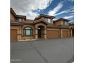 Attractive townhome with a well-kept exterior, a tiled roof, and convenient garage access at 16820 E La Montana Dr # 105, Fountain Hills, AZ 85268