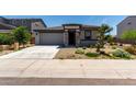 Beautiful single-story home with a two-car garage, stone accents, and desert landscaping in a tranquil neighborhood at 18021 W Avenida Del Sol --, Surprise, AZ 85387