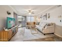 Bright living room featuring a neutral color palette, stylish furniture, and sliding glass door access to the patio at 2025 E Campbell Ave # 107, Phoenix, AZ 85016
