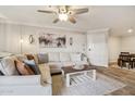 Comfortable living room featuring a plush sectional sofa, a decorative coffee table, and bright natural light at 2025 E Campbell Ave # 107, Phoenix, AZ 85016