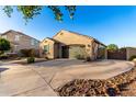 Attractive single-story home featuring a landscaped front yard and wide driveway at 21084 E Cherrywood Dr, Queen Creek, AZ 85142