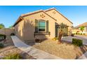 Beautiful single-story home with a tidy front yard, gravel landscaping, and a charming window box at 21084 E Cherrywood Dr, Queen Creek, AZ 85142