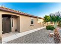 Side view of a single-story home with well-maintained gravel landscaping and a side entrance at 21084 E Cherrywood Dr, Queen Creek, AZ 85142
