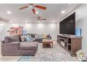 Open-concept living room featuring recessed lighting, a sectional couch, and a large screen TV at 2114 N 69Th Pl, Scottsdale, AZ 85257