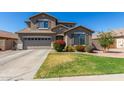 Beautiful two-story home with landscaped front yard and attached two-car garage at 2152 W Sunshine Butte Dr, San Tan Valley, AZ 85144