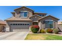 Charming two-story home featuring shutters, a well-maintained lawn, and beautiful landscaping at 2152 W Sunshine Butte Dr, San Tan Valley, AZ 85144