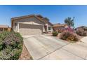 Beautiful single-story home with two car garage, low maintenance landscaping, and concrete driveway at 22534 W Pima St, Buckeye, AZ 85326