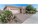 Charming single-story home with a brick-paved driveway and stone-accented entryway at 24953 N 172Nd Dr, Surprise, AZ 85387