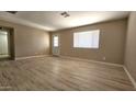 Inviting living room featuring wood-look floors and a window providing ample natural light at 2548 E Encanto St, Mesa, AZ 85213