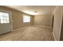 Bright living room with stylish wood-look flooring and a window with natural light at 2548 E Encanto St, Mesa, AZ 85213