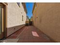 Low-maintenance backyard showcasing a paved patio area between neighboring properties at 2640 N 73Rd Gln, Phoenix, AZ 85035