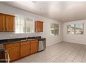 Spacious kitchen area offering ample cabinetry, stainless steel appliances, and a light-filled adjacent dining space at 2640 N 73Rd Gln, Phoenix, AZ 85035