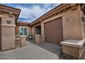Inviting gated entrance with a cozy seating area next to the garage at 3522 W Rushmore Dr, Anthem, AZ 85086