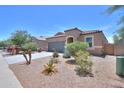 Well-maintained single-story home with desert landscaping, tile roof, and a spacious driveway at 36467 W Pampoloma Ave, Maricopa, AZ 85138