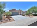 Inviting single-story home with desert landscaping, tile roof, and a wide driveway at 36467 W Pampoloma Ave, Maricopa, AZ 85138