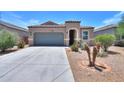 Attractive single-story home with desert landscaping, tile roof, and a spacious driveway at 36467 W Pampoloma Ave, Maricopa, AZ 85138