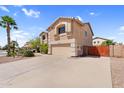 Wide driveway leads to a two-car garage with a well maintained yard and neutral stucco exterior at 3786 S Chaparral Rd, Apache Junction, AZ 85119