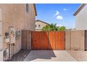 Solid wood gate between two homes provides security and leads to additional parking or backyard at 3786 S Chaparral Rd, Apache Junction, AZ 85119